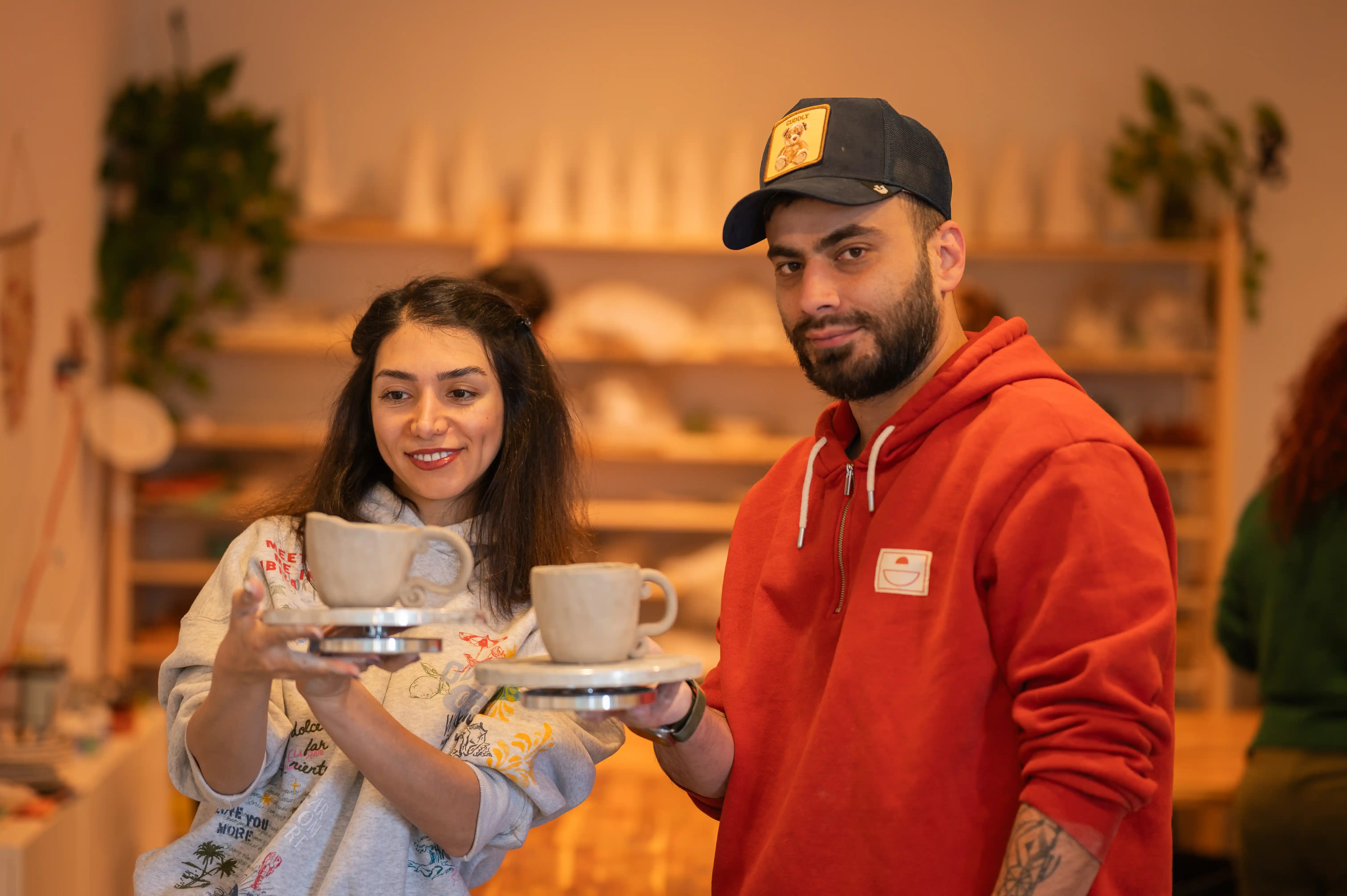 Students showing off their finished mugs