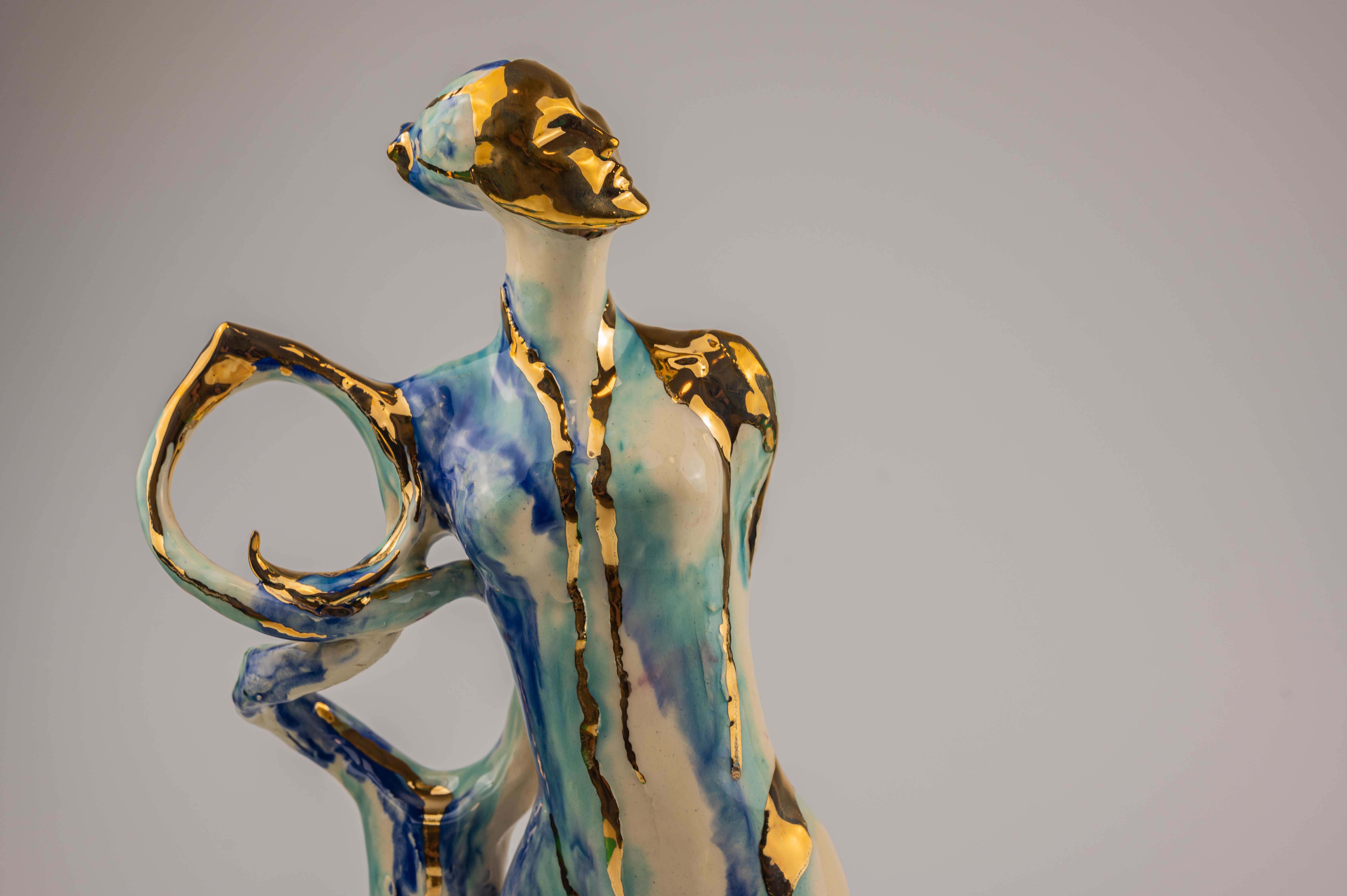 Sculptural ceramic artwork with blue and gold glazing