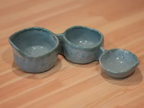 A speckled blue-grey dish with three joined bowls