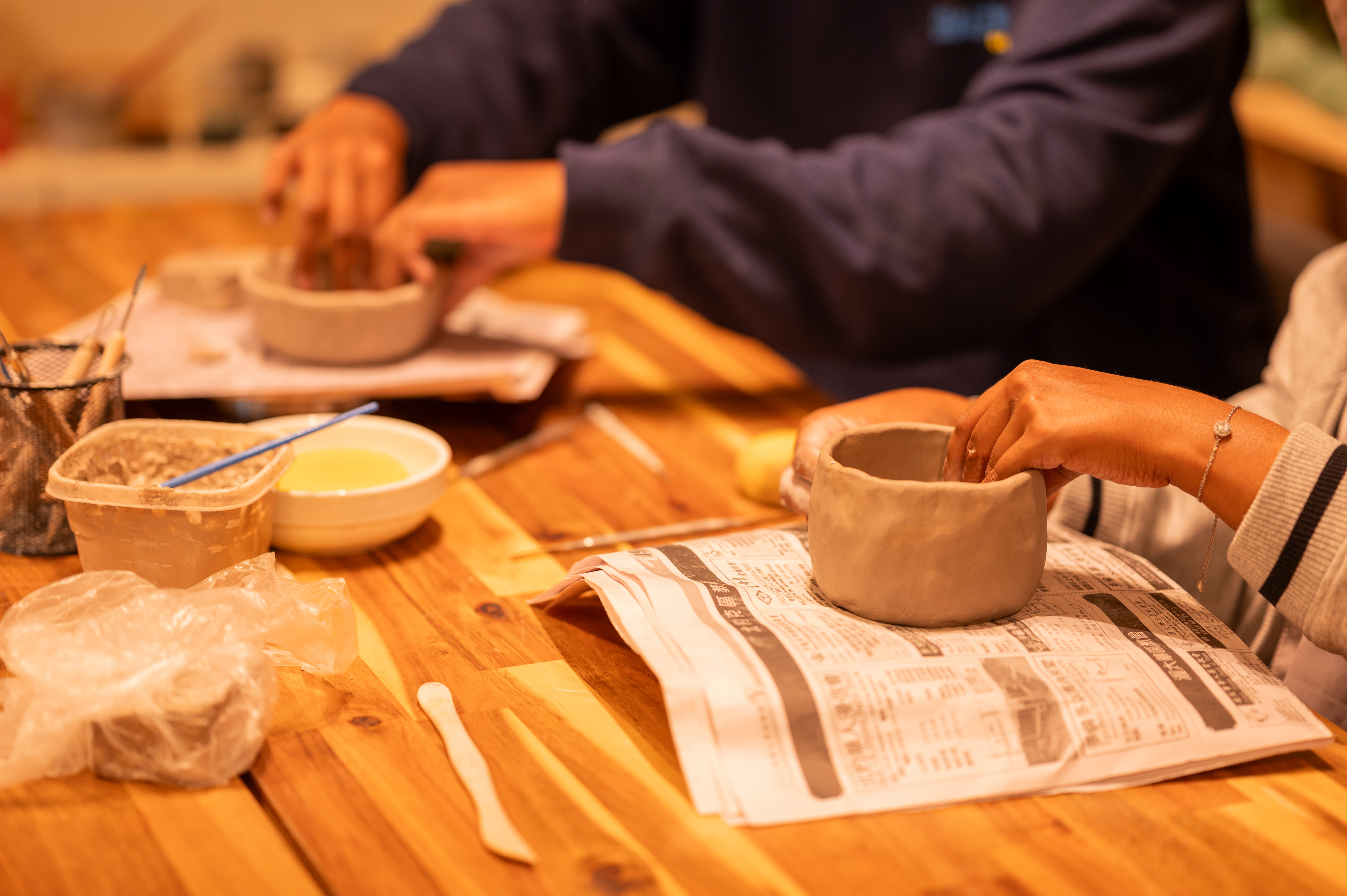 New pottery student creating a hand-built bowl