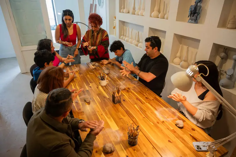 Wide view of the pottery studio during a workshop, showcasing the complete learning environment.