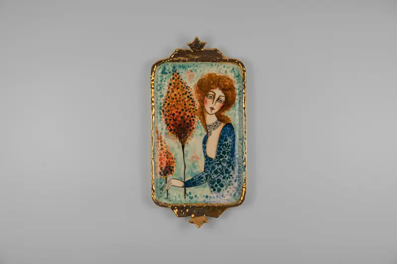 An elegant rectangular ceramic piece with luxurious gold trim featuring a beautifully painted female portrait.